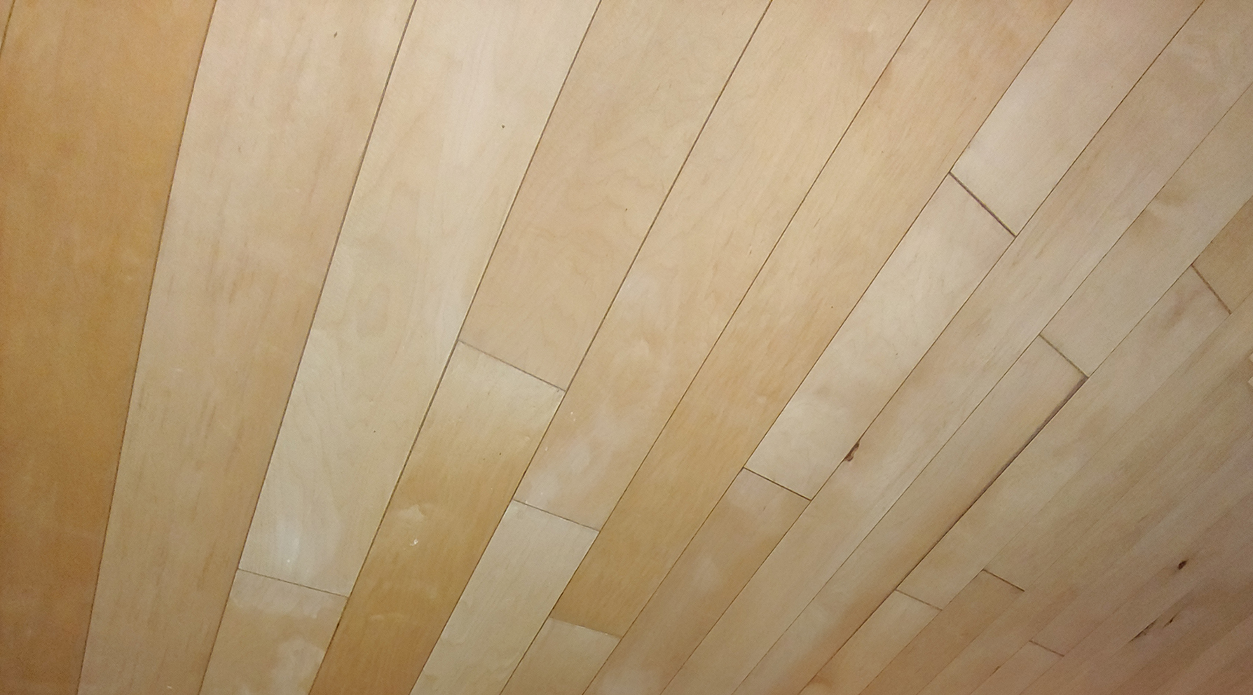 Backs of hardwood planks showing on the ceiling